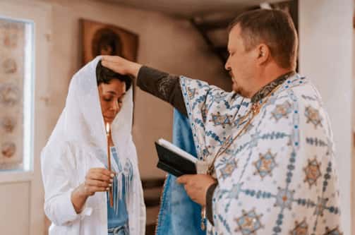 The father gives blessings to the woman