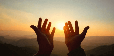 A person open his hands for morning blessings and prayers.