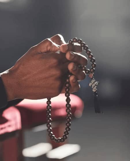 A man hand shows he is praying for the blessings.