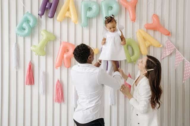 Father and Mother celebrating her daughter's Birthday